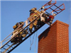 Firefighters on a Ladder at a Chimney